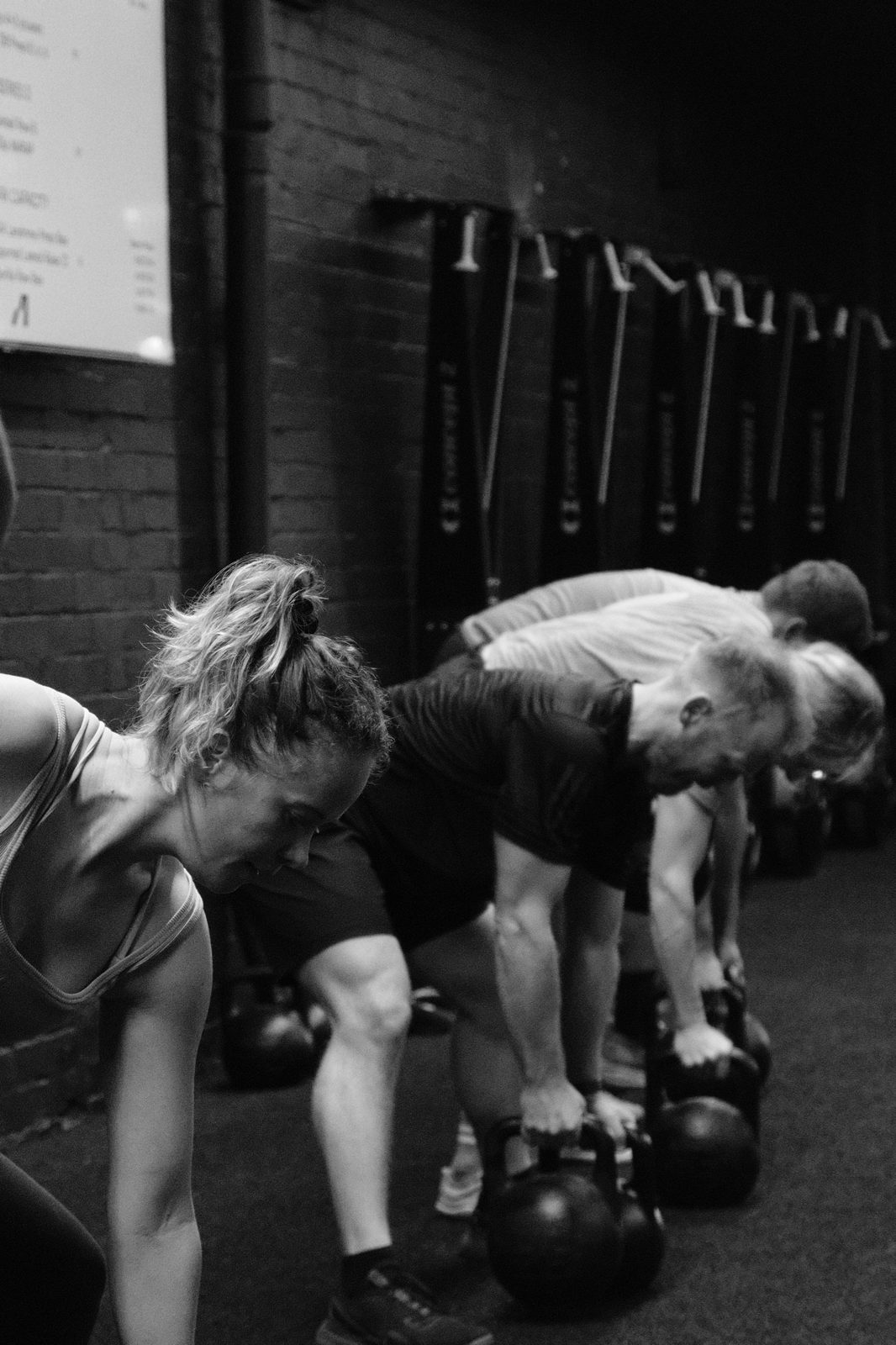 Members setting up for kettlebell swings in a coached Assembly Training class